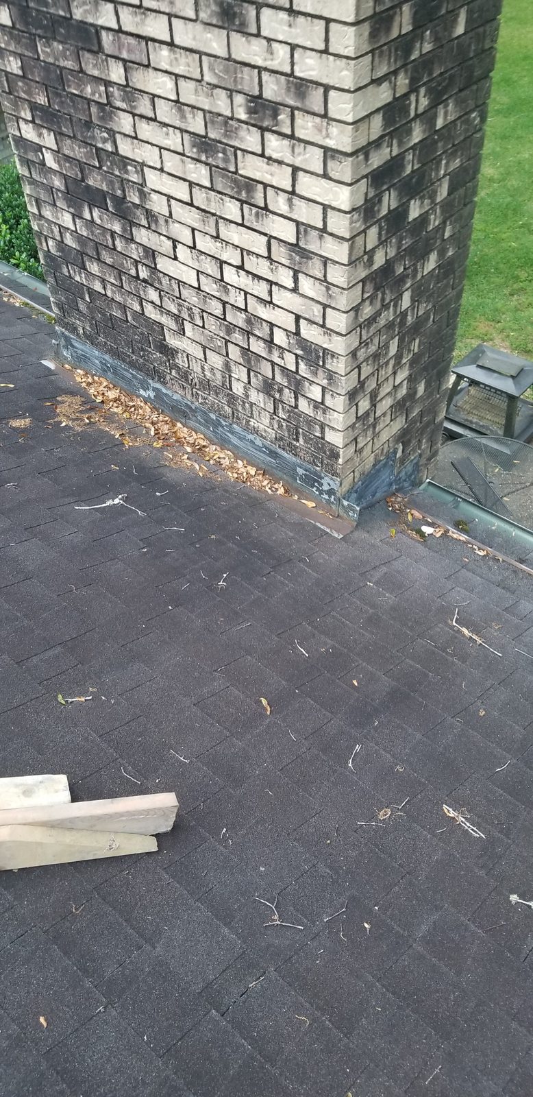 Failed chimney flashing sealed with roofing tar, Mobile AL